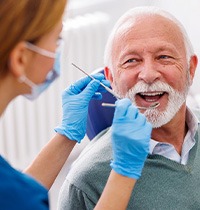 Man smiles at dentist