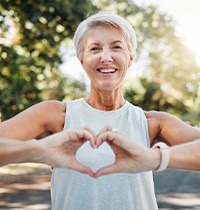 Lady makes shape of heart with her hands