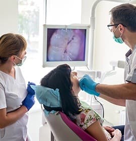 Dentist and patient looking at intraoral images