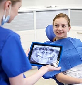 Smiling young girl in dental chair