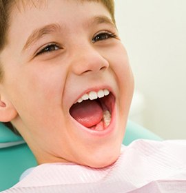 Shocked girl holds her knocked-out tooth