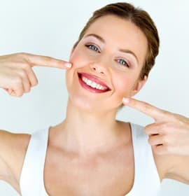 woman pointing to teeth