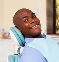 Man smiles after getting dental implants in Brampton