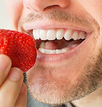 smiling young woman with dental implants in Brampton