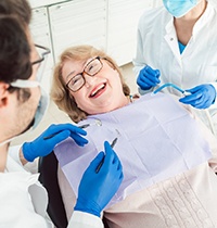Woman smiling while looking at dentist in treatment chair