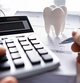 A patient calculating the cost of their dental care