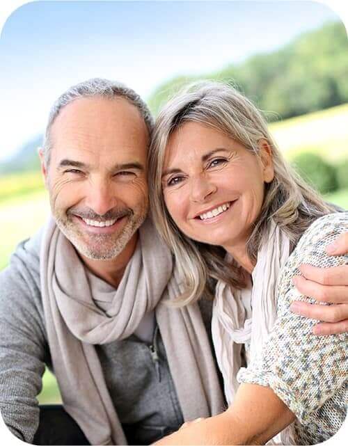 Smiling older man and woman outdoors