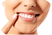 Closeup of patient pointing to smile