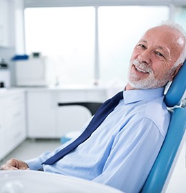 Male dental patient rubbing jaw in pain