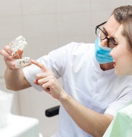 a dentist explaining dental implant technology in Brampton 