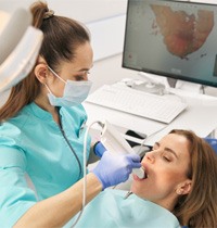 a dentist using TRIOS digital impressions for dental implant procedure