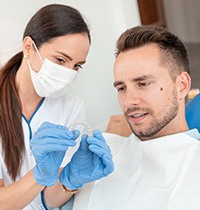 Dentist showing patient his Invisalign trays