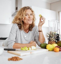 a woman with dental implants sticking to a healthy diet