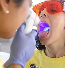 Woman receiving oral cancer screening