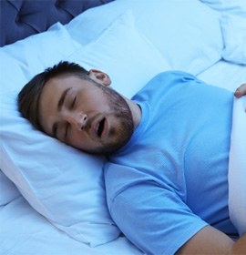 Man with sleep apnea in Brampton, ON sleeping and snoring