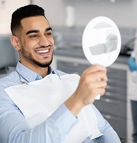 A man admiring his new porcelain veneers