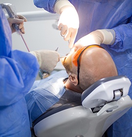 Dentists performing a wisdom tooth extraction surgery