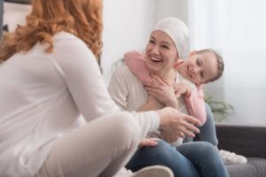 cancer patient with her child, speaking to another female