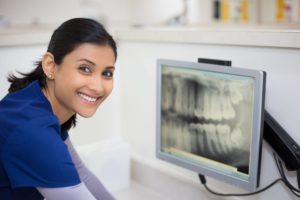 doctor looking at xray of teeth