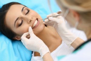 Woman having dental exam performed