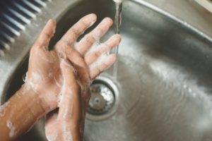 person washing their hands 