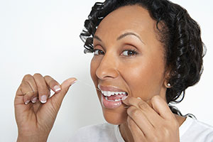 woman flossing her teeth before bed brampton dentist