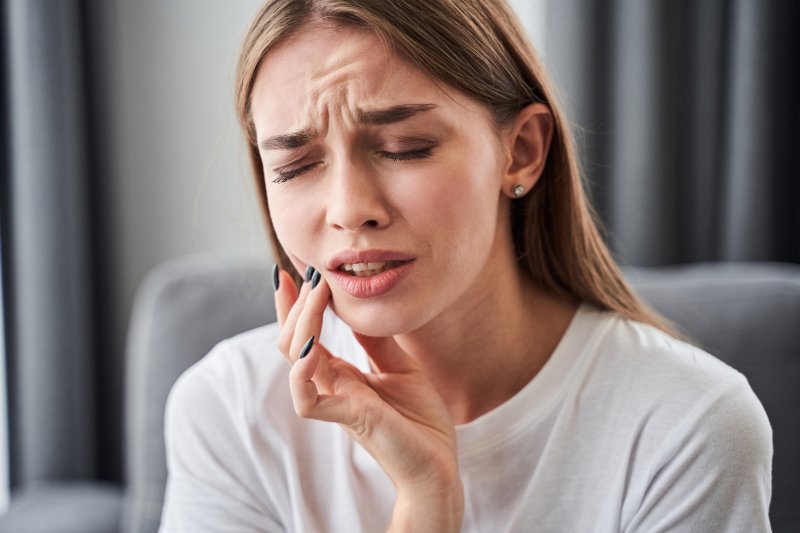 young woman with dental emergency