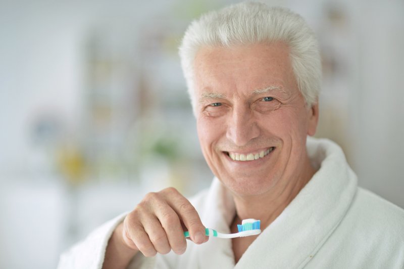 mature man practicing dental hygiene tips in Brampton