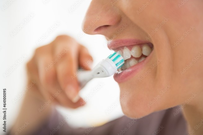 person brushing teeth before eating breakfast