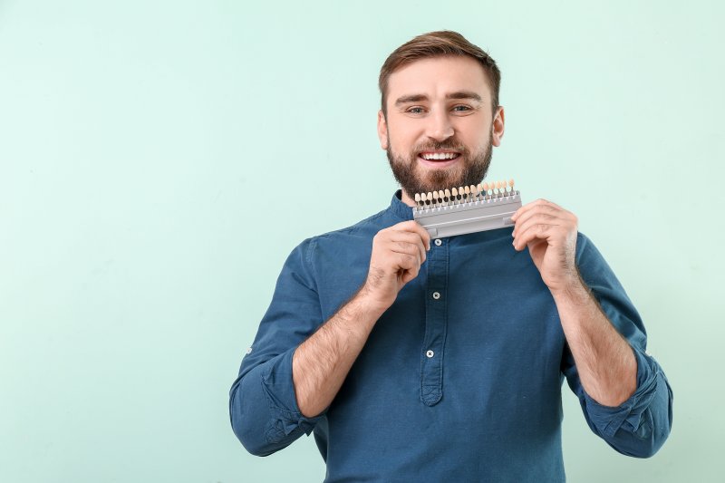 Man holding a palette of veneers