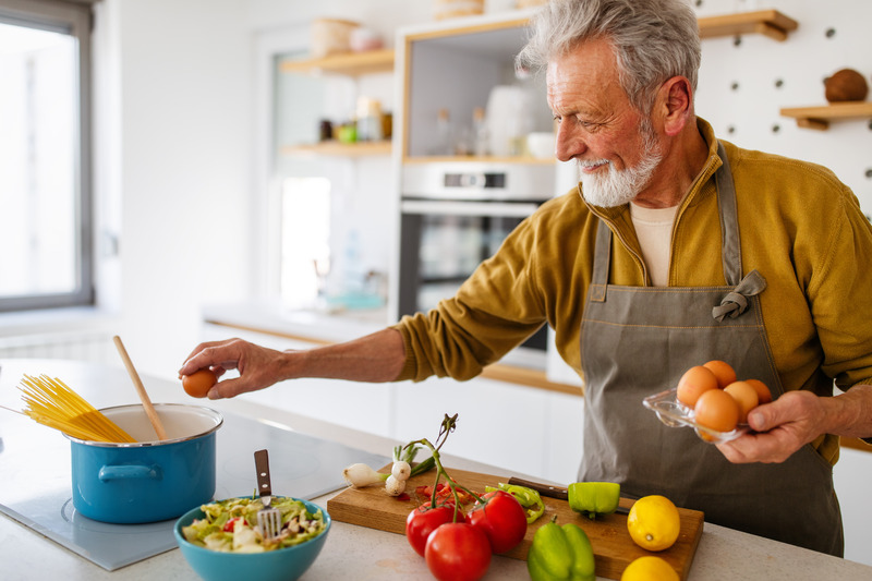 Dentures patient preparing food